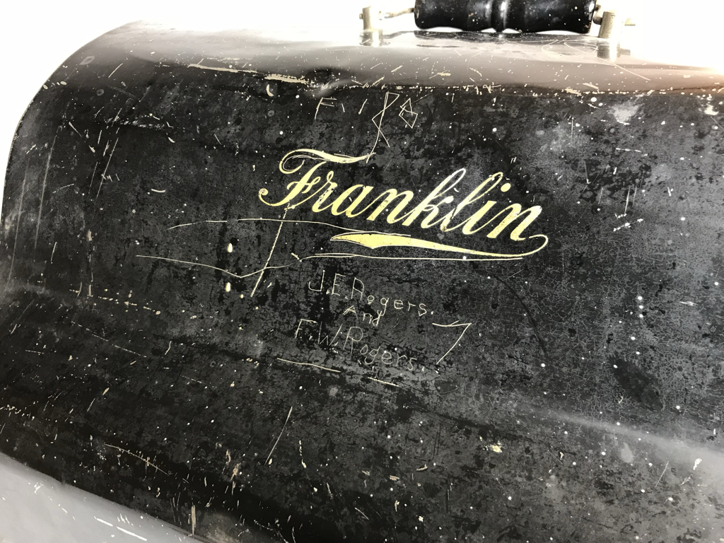 Names of probable machine owners are scratched onto the painted case