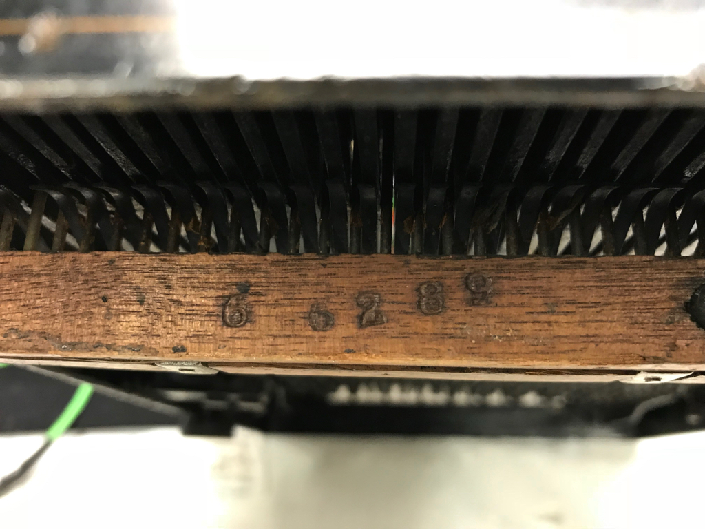 Serial number stamped on wooden frame