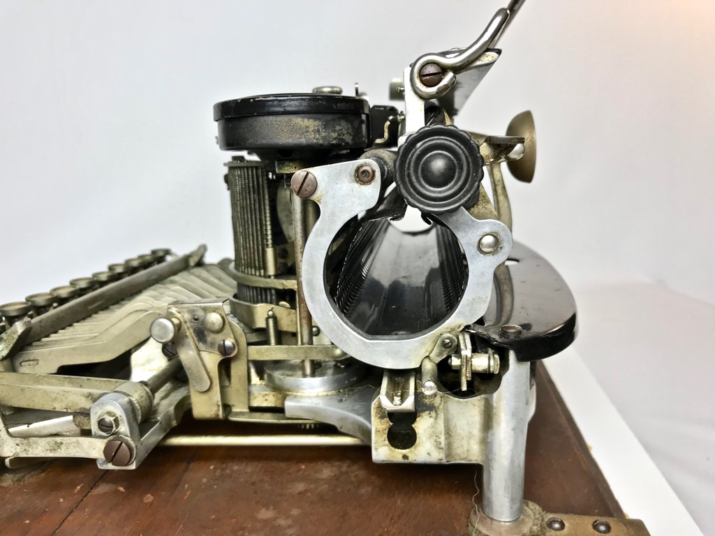 Note that paper must be rolled up and inserted into the paper cage then rolled onto the platen.