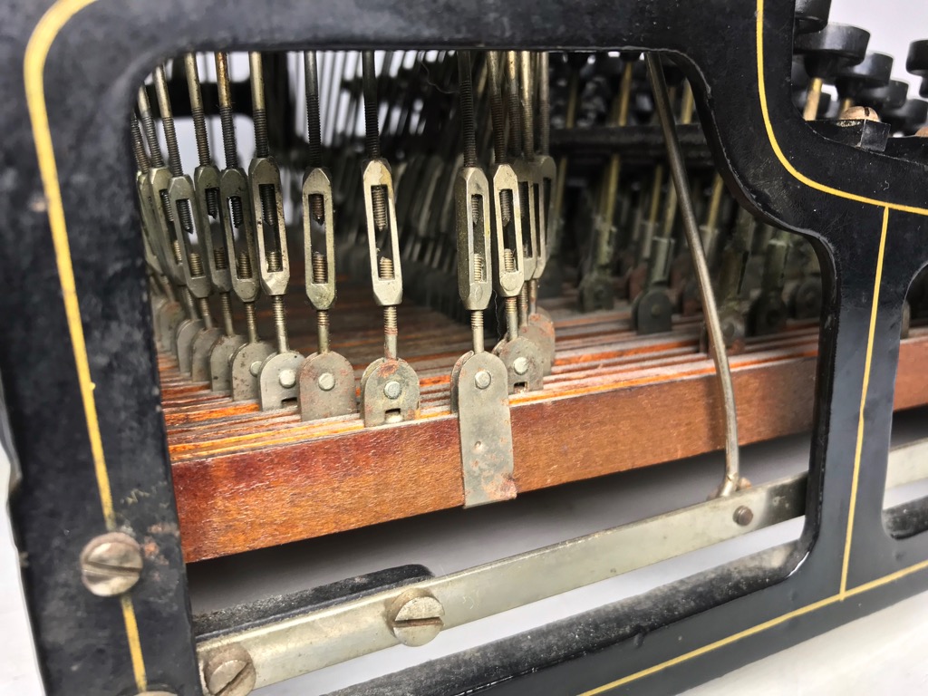 The small turnbuckles conected to the wooden levers allowed for precise adjustment for each key.