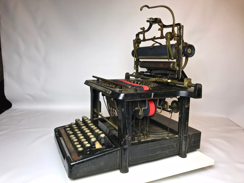 Platen and carriage in raised position where typist could read what has been typed