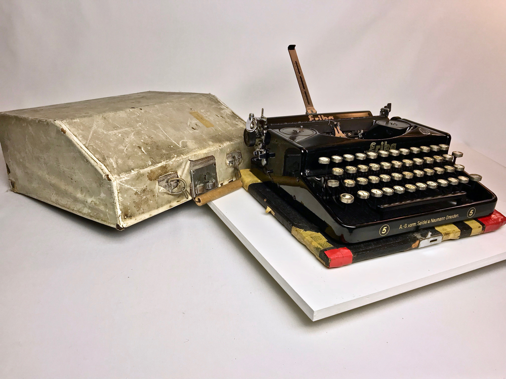 Typewriter shown with case